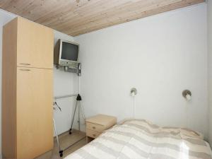 a bedroom with a bed and a tv on the wall at Nice Home In Hadsund W- in Hadsund