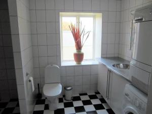 a bathroom with a toilet and a sink and a window at Amazing Home In Höganäs With 2 Bedrooms And Wifi in Höganäs +15 photos