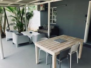 ein Holztisch und Stühle auf einer Terrasse in der Unterkunft Lakaz Kokas in Pereybere + 20 Fotos