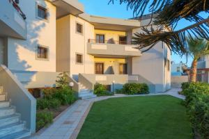 a house with a lawn in front of it at John Mary Apartments by Estia in Gouves