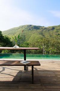 a wooden table with a plant on top of it at Marmaram Heritage in Vagamon