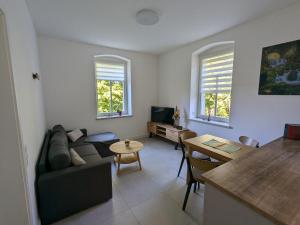a living room with a couch and a table at Ferienwohnung "EDDI" in Hohnstein