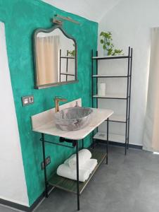 a bathroom with a sink and a mirror at Cueva Pilones in Graena
