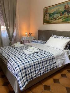 a bedroom with a bed with two towels on it at La Bouganville House in Naples