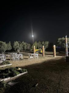 a group of tables and chairs in a park at night at Spacious villa with pool in Tarragona in Tarragona