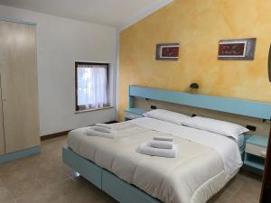 En eller flere senge i et værelse på Alloggio La Pesa