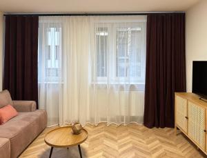 a living room with a couch and a window at Tamaja 2 in Bielsko-Biała