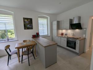 a kitchen with a counter and a table in it at Ferienwohnung "EDDI" in Hohnstein