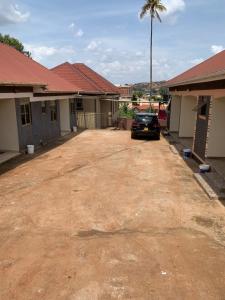 a car parked in the driveway of a house at Luxury 1 BER Apartment Bukoto in Kampala