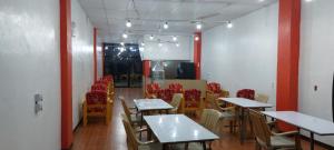 a dining room with tables and chairs in a room at SID'S Traveller's INN in General Santos