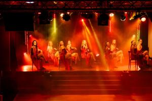 a group of women sitting on a stage at Villages Clubs du Soleil - LES MENUIRES in Les Menuires