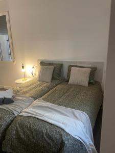 a bedroom with two beds with pillows on them at La Pitxotxa - Apartamento in Novelda