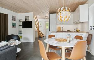 a kitchen and living room with a white table and chairs at Gorgeous Home In Hobro in Hobro