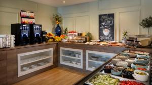 a bakery with a counter with fruits and vegetables at Eola Leisure Rooms in Stara Baška