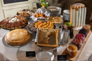 a table with various pastries and other foods on it at Eola Leisure Rooms in Stara Baška