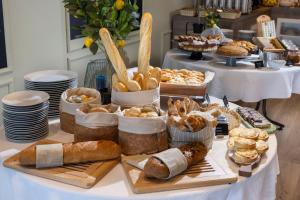 a table with various pastries and breads on it at Eola Leisure Rooms in Stara Baška