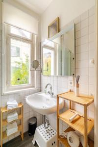 a white bathroom with a sink and a window at Villa Johanna in Bad Herrenalb