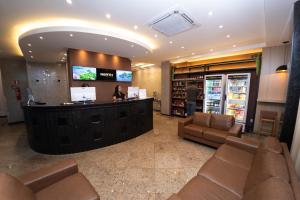 a lobby of a store with a woman at a counter at NORTH HOTEIS in Montes Claros