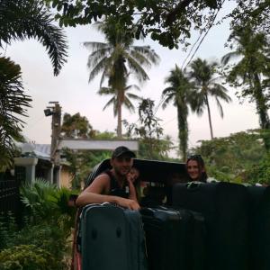 two people riding in a train with luggage at Layang Layang Home in El Nido +116 photos