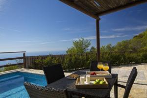 a table with a tray of fruit and drinks on it at Villa Ersi in Chortáta