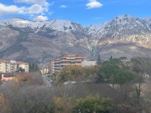 a city with mountains in the background with trees and buildings at La casetta del Pastore in Sulmona