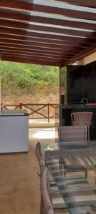 a living room with a glass table and a couch at Chalé Serrano in Guaramiranga
