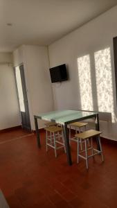 a room with a table and two chairs and a television at Bel Appartement Fonctionnel,2 grandes chambres separer plus un bz,WI FI,Clim in Digoin