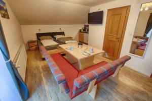 a living room with a couch and a table at Haus Burgel inklusive Königscard in Vils