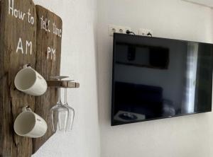 a wall with a tv and mugs on a wall at Luxury Lovran Apartments with Swimming Pool in Lovran