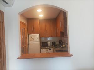 a kitchen with an archway in the middle of it at APARTAMENTO1 dormitorio in La Cala de Mijas +3 photos