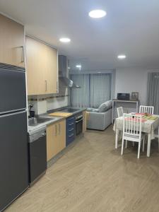 a kitchen and living room with a table and a couch at HyP - D'cuca in Islotes Erbedosas +36 photos