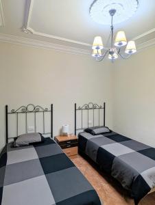 two beds sitting next to each other in a bedroom at CHC - Apartamento Los Silos Tulipanes 2 in Los Silos