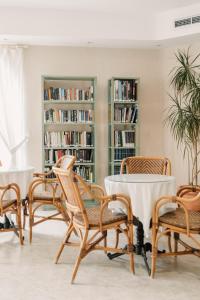a group of chairs and a table in a library at Aparthotel Villas La Manga in La Manga del Mar Menor