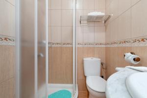 a bathroom with a shower and a toilet and a sink at One Life One Dream Gran Canaria in Carrizal +30 photos