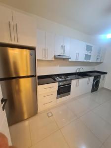 a kitchen with a stainless steel refrigerator and a dishwasher at Tabarja hills in ‘Ayn aş Şughayrah