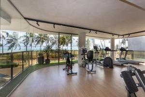 a gym with treadmills and exercise equipment in a building at Yacht by Hosppedar in João Pessoa