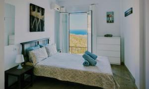 a bedroom with a bed with a view of the ocean at Mijas Pueblo, 3 terraces & pool with sea view in Mijas