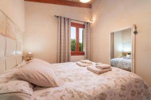 a bedroom with a bed with two towels on it at Can Gardo in Pollença +26 photos