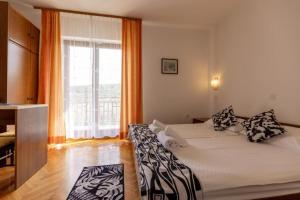 a bedroom with a bed and a large window at B&B Kovač in Portorož