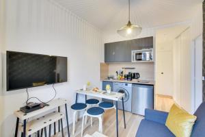 a kitchen with a table and two stools in a room at Bluestay 141 - Superb apartment in Bagnolet +9 photos
