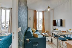 a living room with a blue couch and a table at Bluestay 141 - Superb apartment in Bagnolet