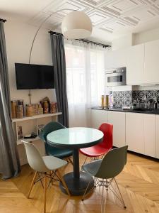 a kitchen with a table and four chairs at Appartement Seine et Marais in Paris