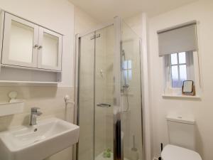 a bathroom with a shower and a sink and a toilet at Pass the Keys Charming Coastal Retreat – 1-Bedroom Flat in Blyth in Blythe +12 photos