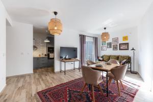 a living room with a table and a couch at Sunny Side Wellness Resort & Spa in Budva