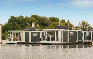 two large boats are docked in the water at House Boat Vrijthof in Maastricht +22 photos