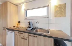 a small kitchen with a sink and a window at House Boat Vrijthof in Maastricht
