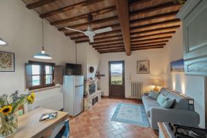 a living room with a couch and a table at Relax Palazzo Monaci in Asciano +26 photos