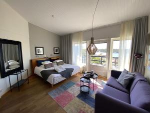 a living room with a bed and a couch at HavsVidden Resort in Geta