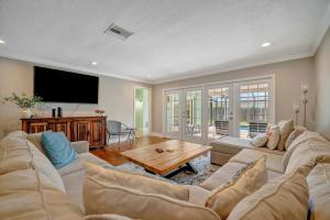 a living room with a couch and a table at The Crown House 4b Pool Home 6 mins to IR Beach in Largo