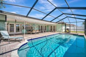 an indoor swimming pool with a glass roof over it at The Crown House 4b Pool Home 6 mins to IR Beach in Largo